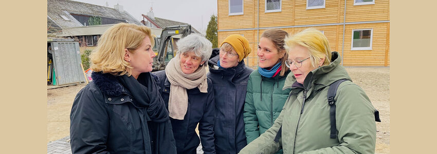 Foto: Hansestadt Lüneburg. OB Claudia Kalisch (links) vor der Gemeinschafts-Unterkunft in Oedeme - mit den Kolleginnen aus der Flüchtlingssozialarbeit Bärbel Osberghaus, Sina Schelm und Annika Richert sowie Sabine Bachmann, die den Bau für die städtische Gebäudewirtschaft betreut.