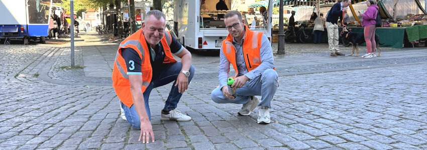 Foto: Hansestadt Lüneburg. Von links: Thomas Knötsch, Abteilungsleiter Grinding der Firma Feind, und Stefan Hammer, der das Projekt für die Hansestadt begleitet, haben diese Woche bereits die Bereiche markiert, in denen das Pflaster angeschliffen werden soll.